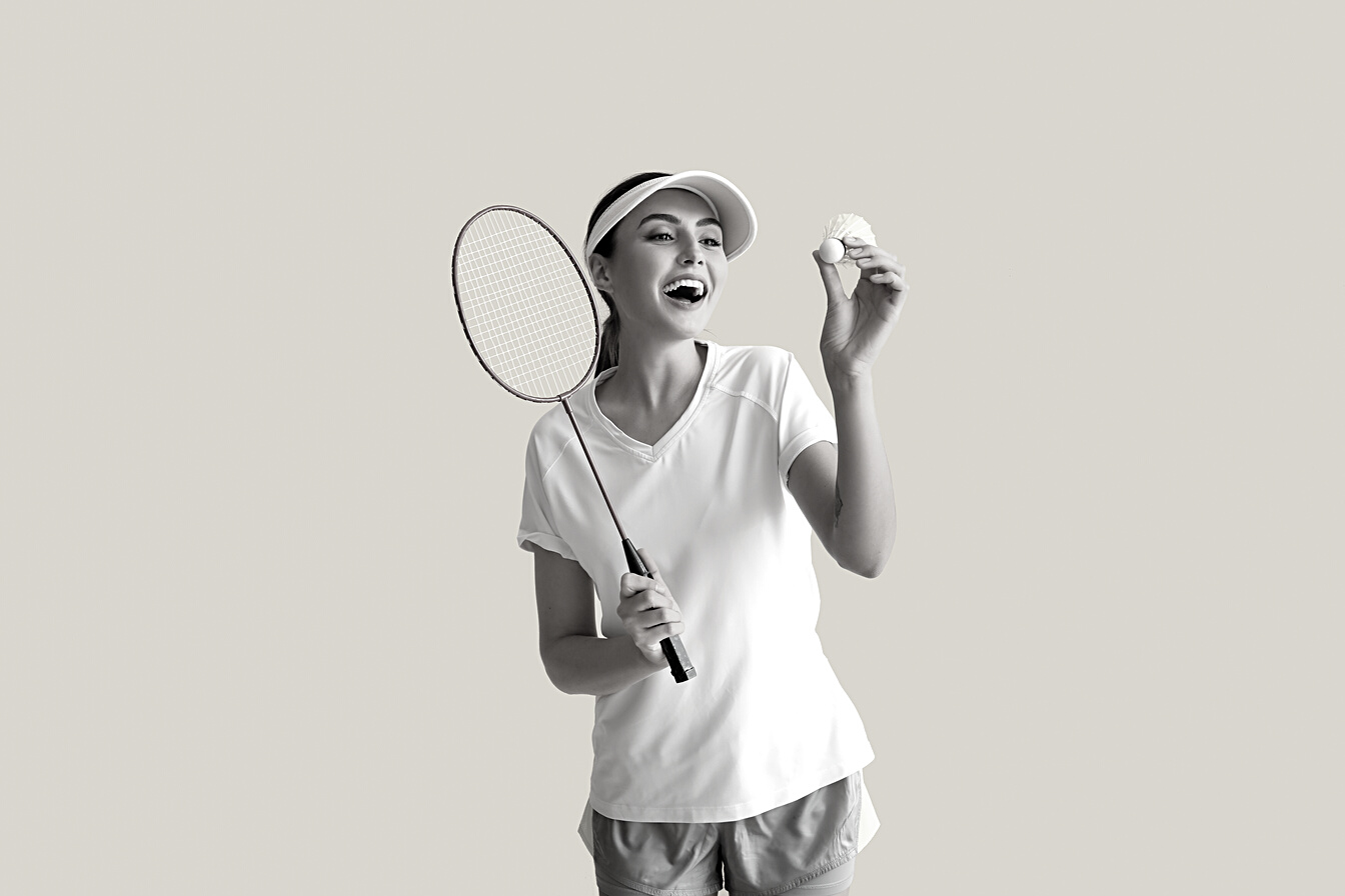 Happy Female Badminton Player on Yellow Background